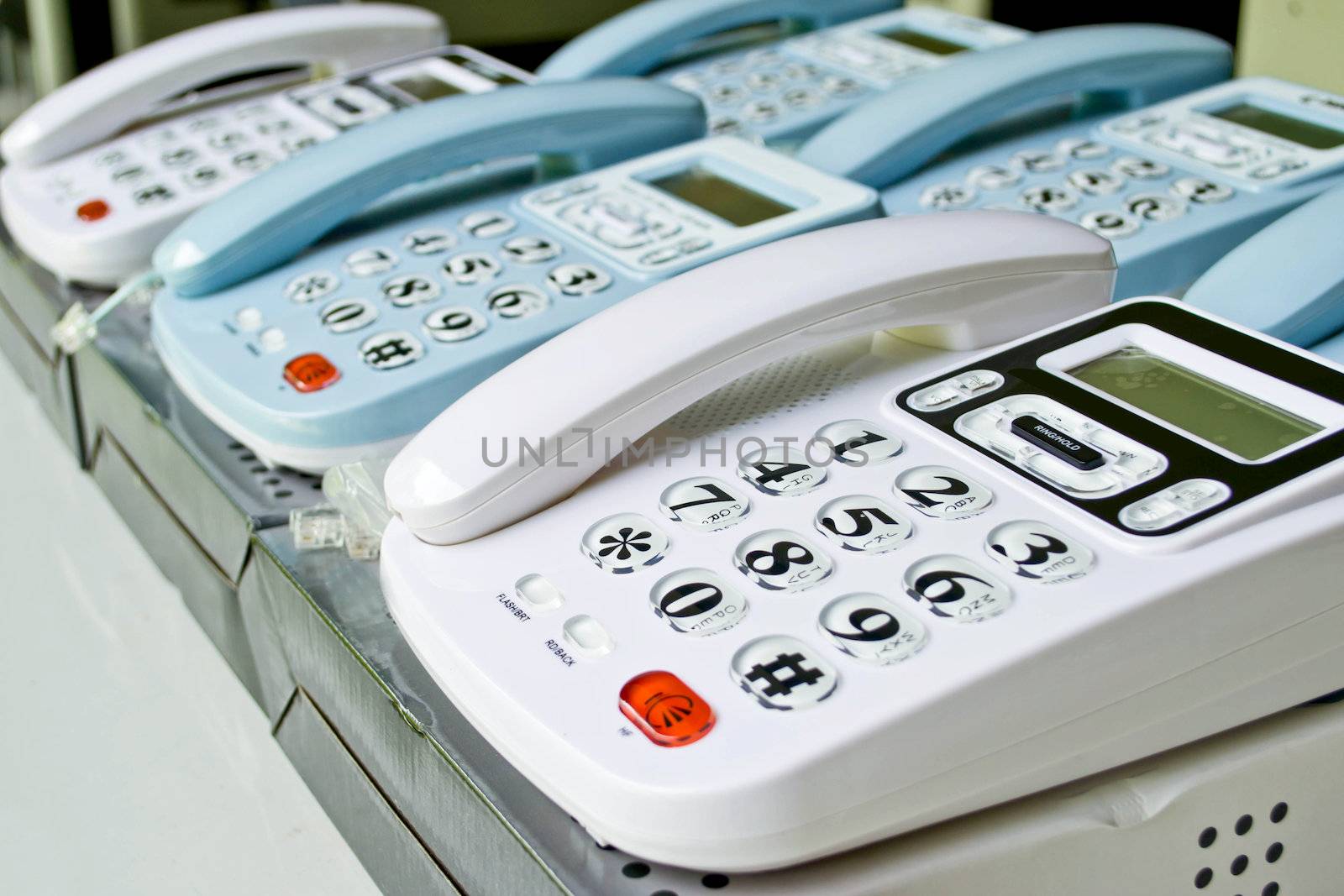 Set of telephones on a desk, receiver close-up