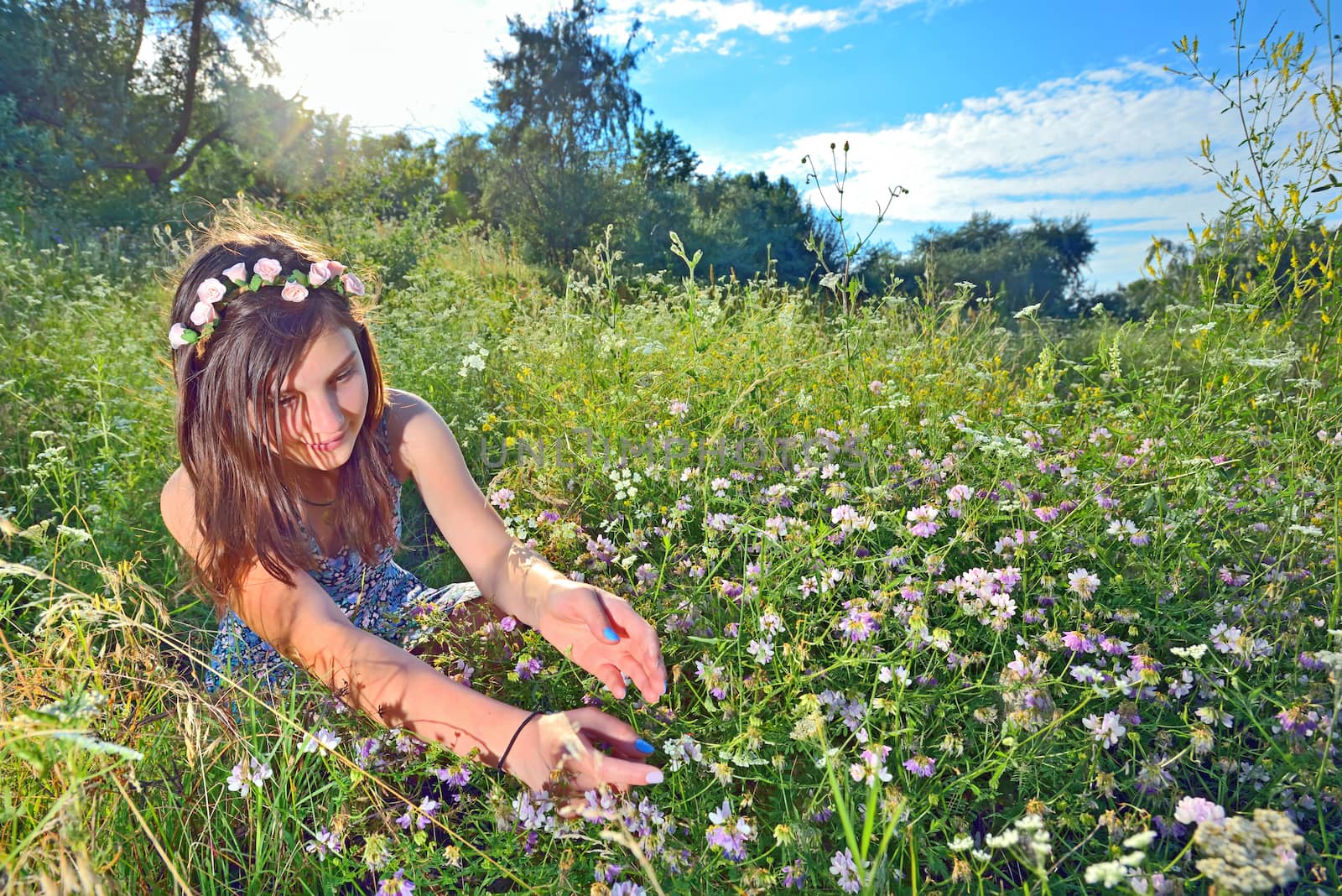 teen sitting outdoors in a field by jordachelr