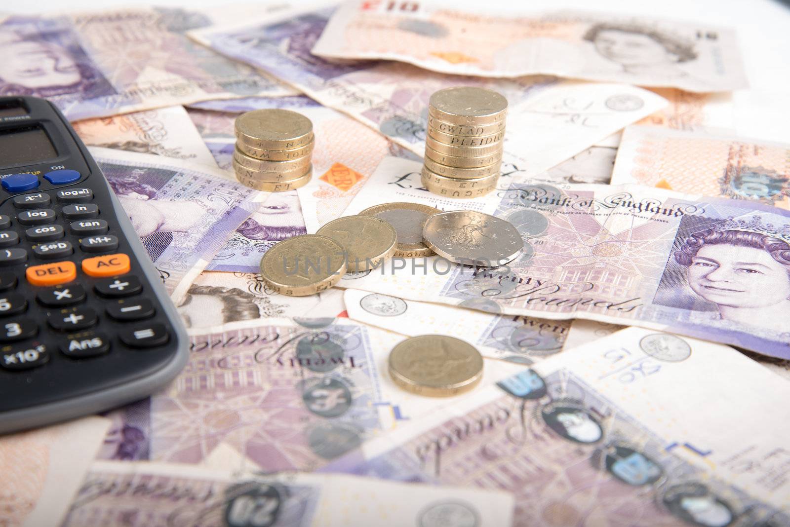 British pound sterling coins and bank notes on desk