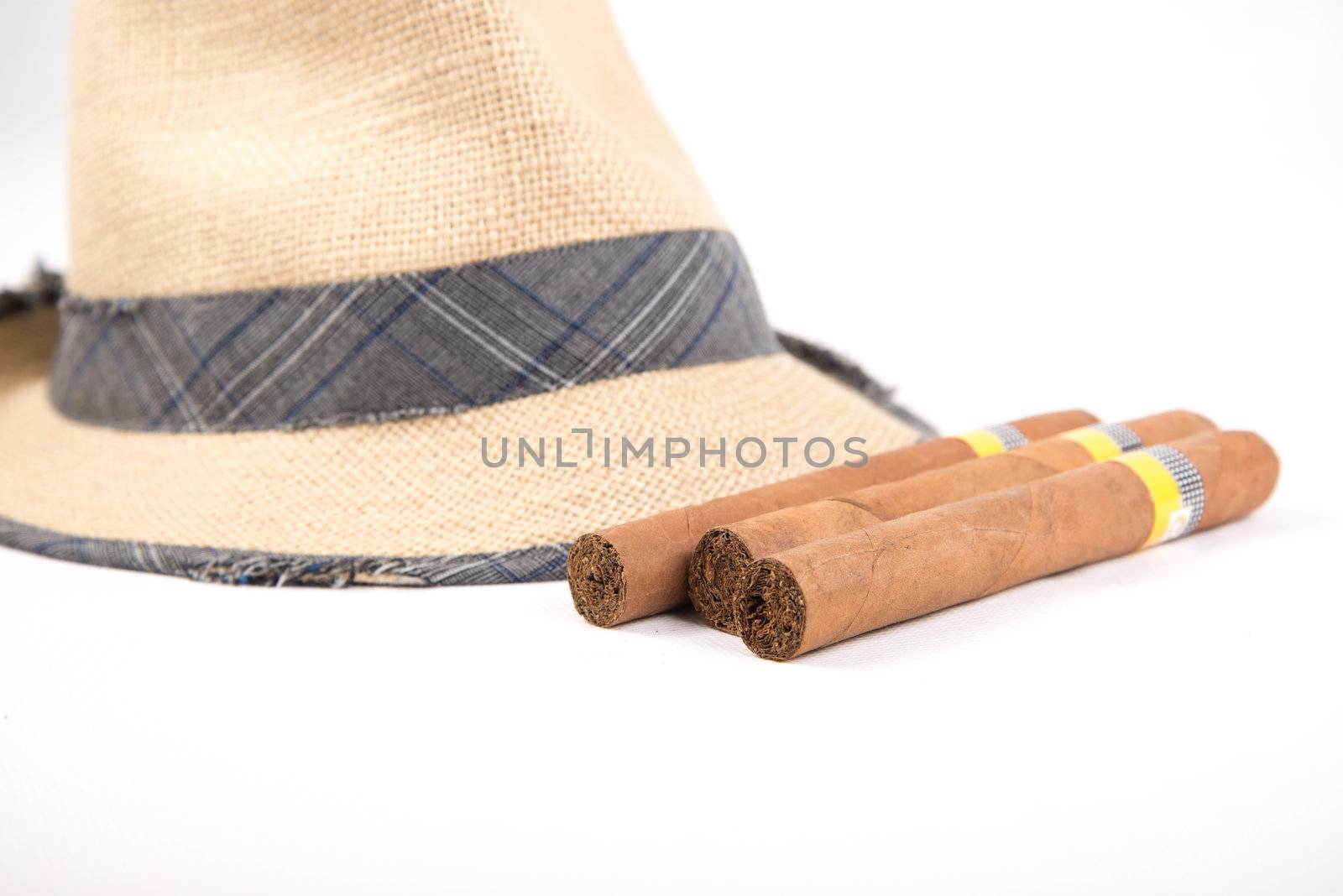 Cuban cigars and hat on white isolated background