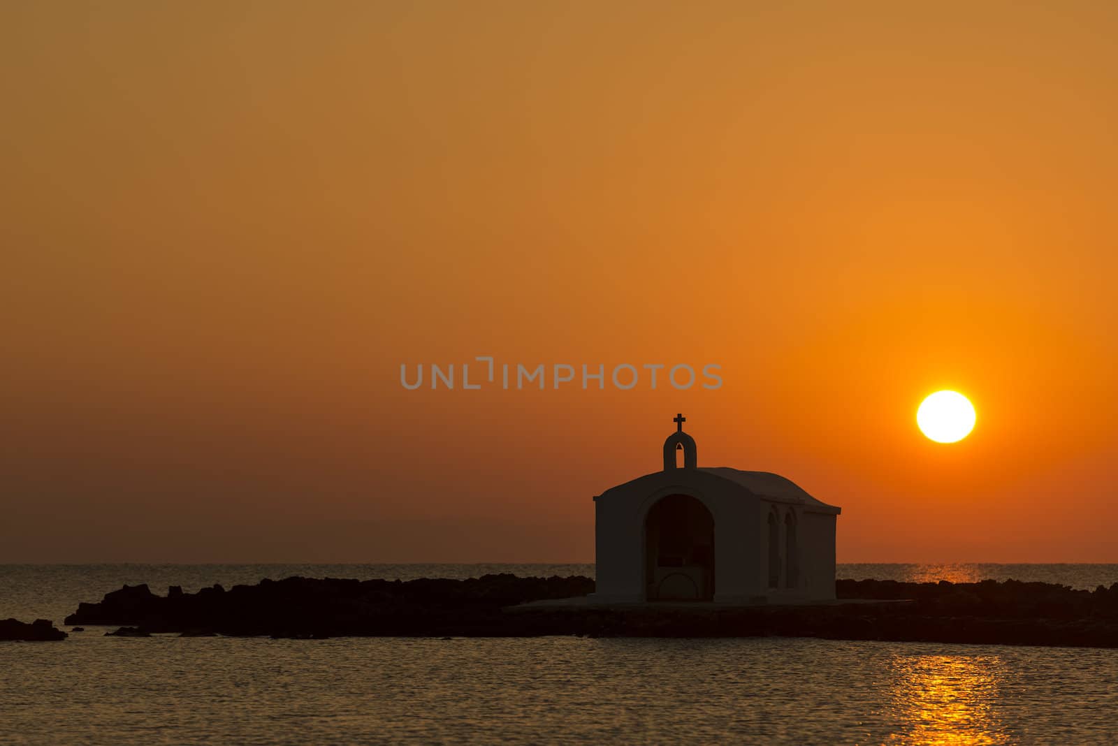 Catholic Church As Silhouette Against The Sunrise In Georgioupolis, Crete, Greece