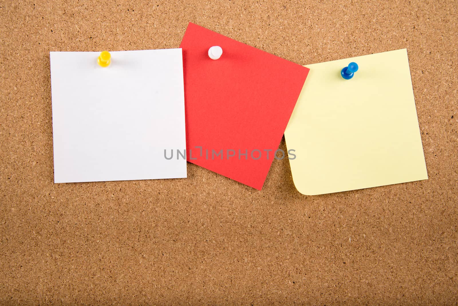 Color sticky memo note cards on cork board