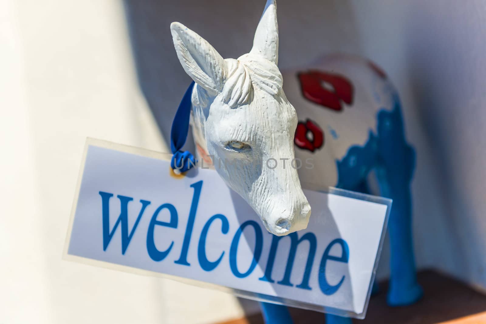 Donkey With Welcome Sign In Santorini by Rainman