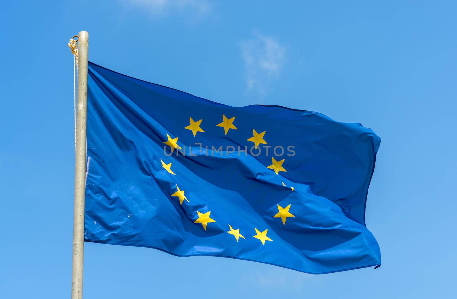 Waving European Union Flag Against The Blue Sky