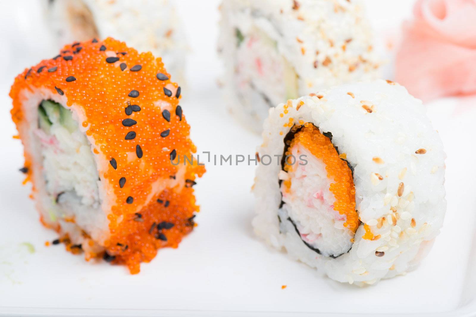 Orange and white shushi rolls. Shallow depth of field. Focus on the white rise