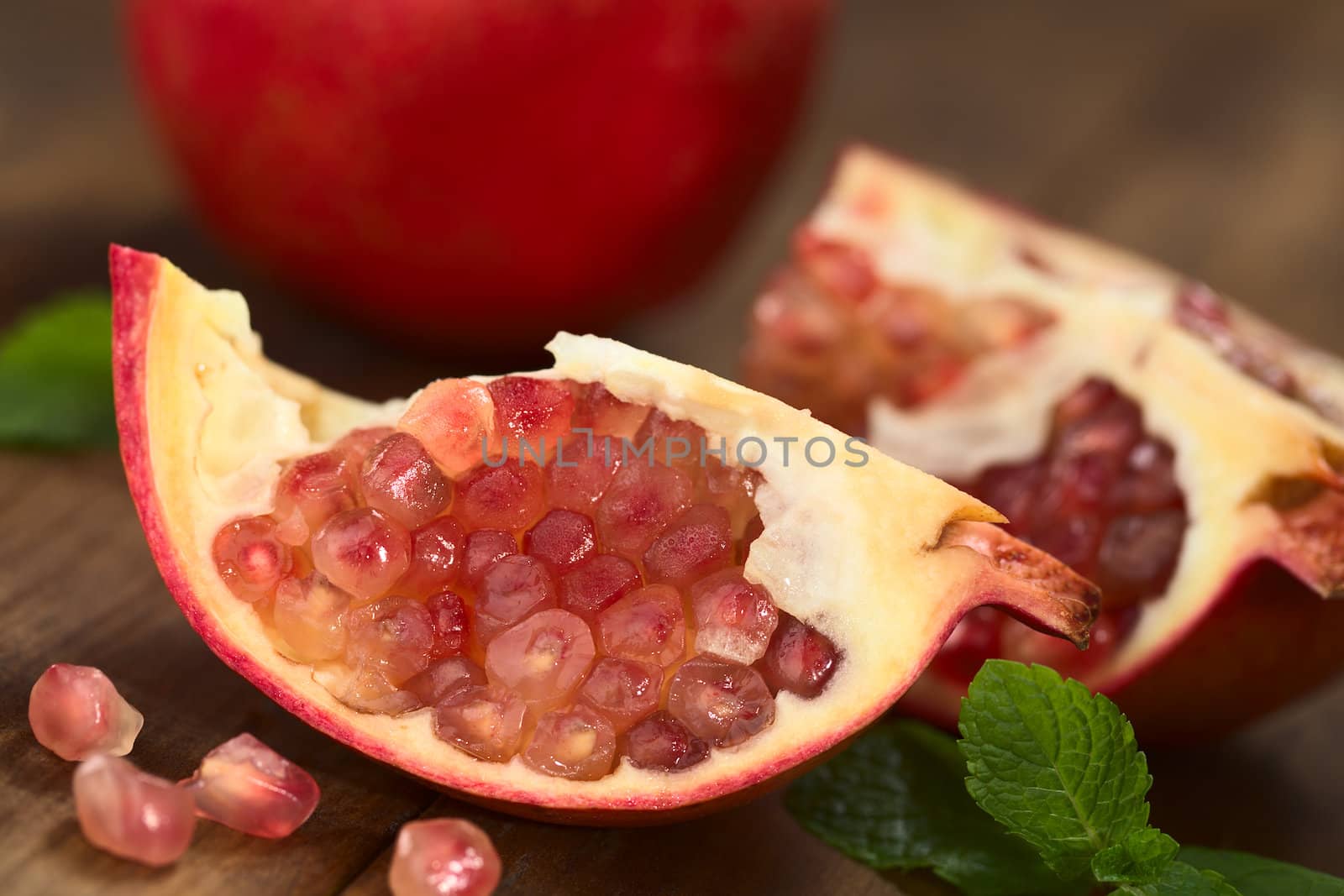 Open pomegranate fruit (lat. Punica granatum) with seeds (Selective Focus, Focus on the lower seeds)