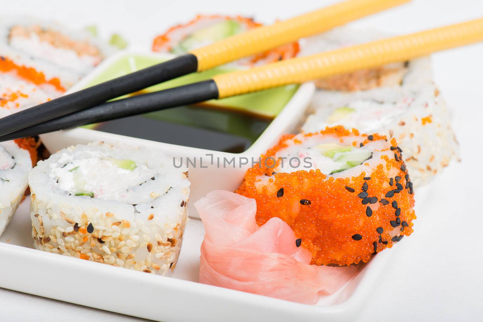 Soy sauce, chopsticks and sushi mix on the plate