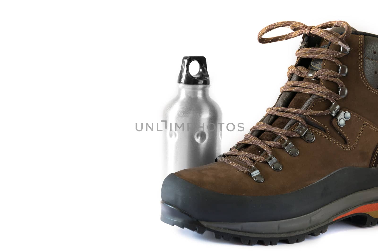 hiking boot on a white paper with a water bottle