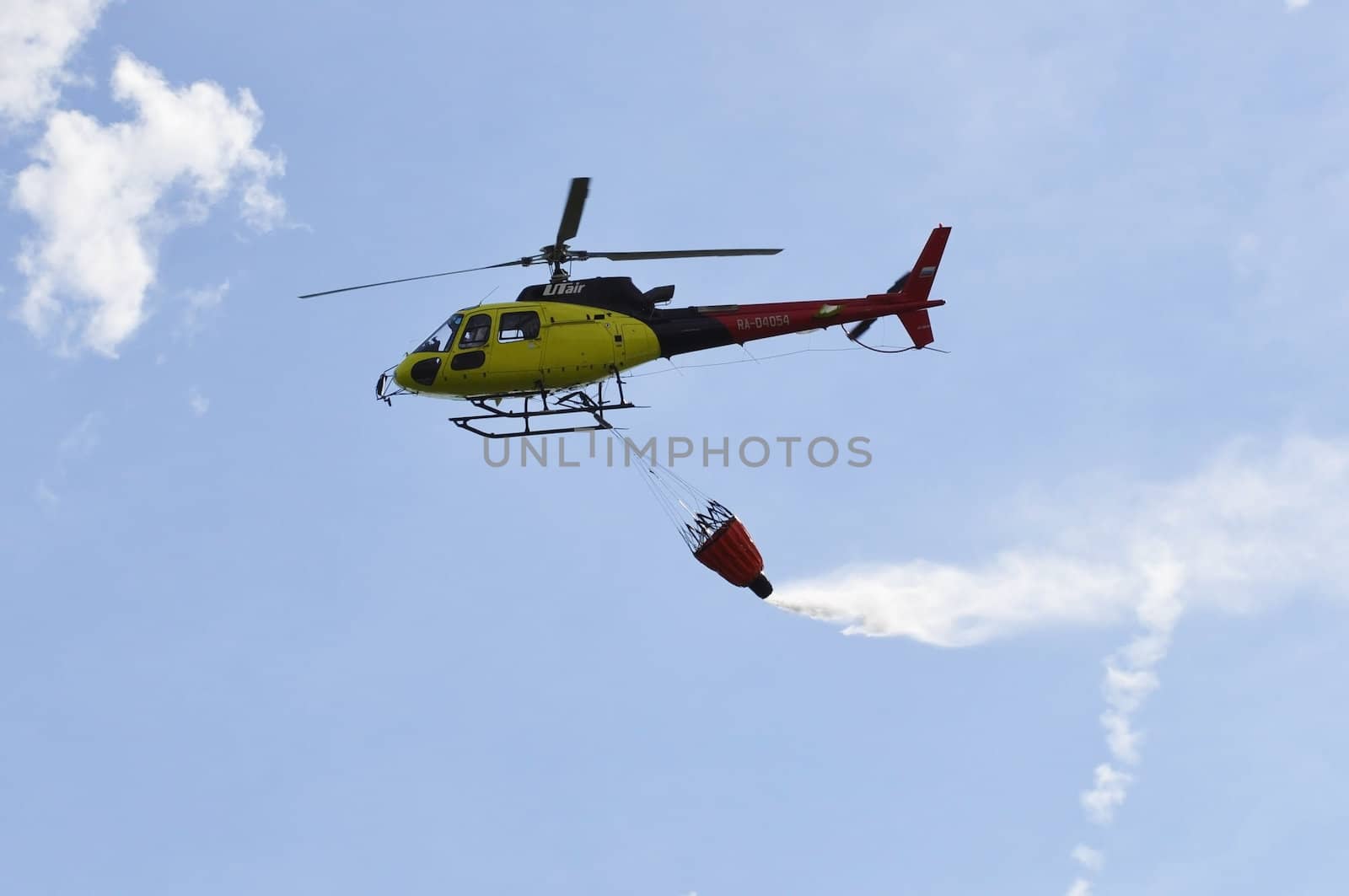 Air show "On a visit at Utair". Tyumen, Russia. 16.08.2014. The helicopter with a suspended water waste ladle