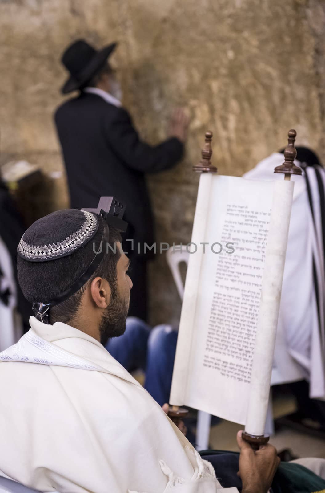 JERUSALEM - JULY 29 : Jewish men prays in the Wailing wall during the Jewish holyday of Tisha B'av , on July 29 2012 in old Jerusalem , Israel 