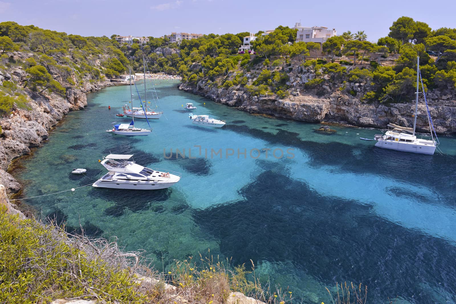 MALLORCA, SPAIN - JULY 17: Crowded Beach With Tourists and Yachts at the Beautiful Bay of Cala Pi on July 17, 2013 in Mallorca, Spain. 