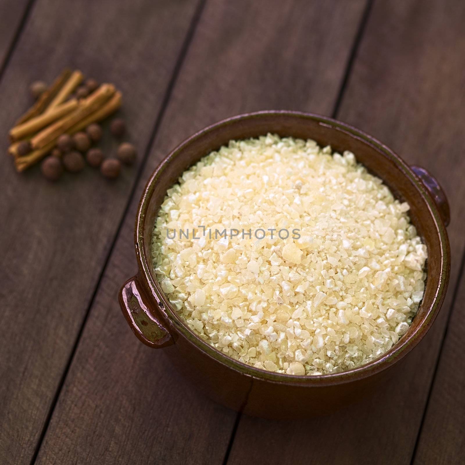 Raw Ecuadorian morocho (coarsely ground white corn) which is used in Ecuador to prepare a dessert with milk and spices similar to rice pudding (Selective Focus, Focus one third into the morocho) 