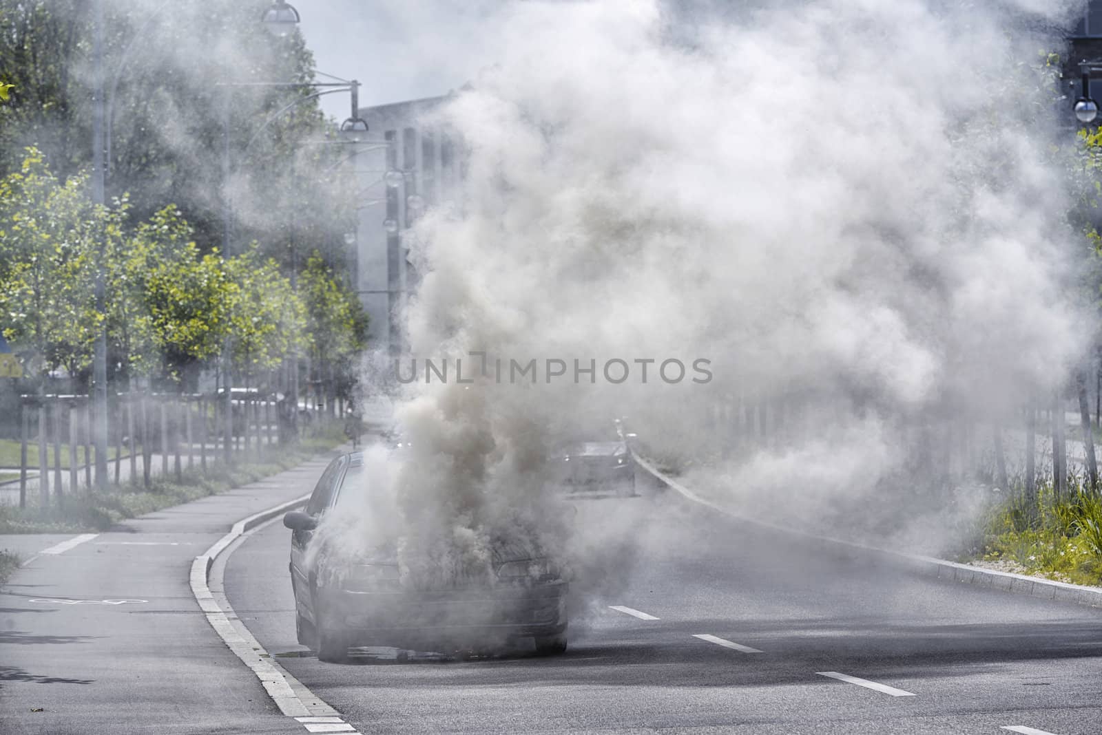 Burning and smoking car on the street