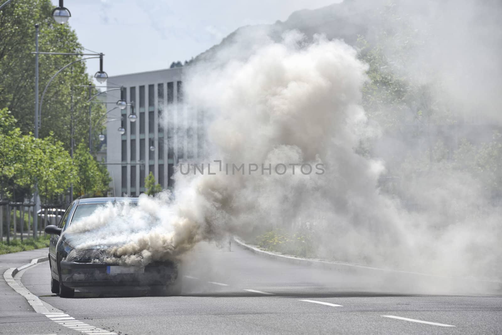 Burning and smoking car on the street