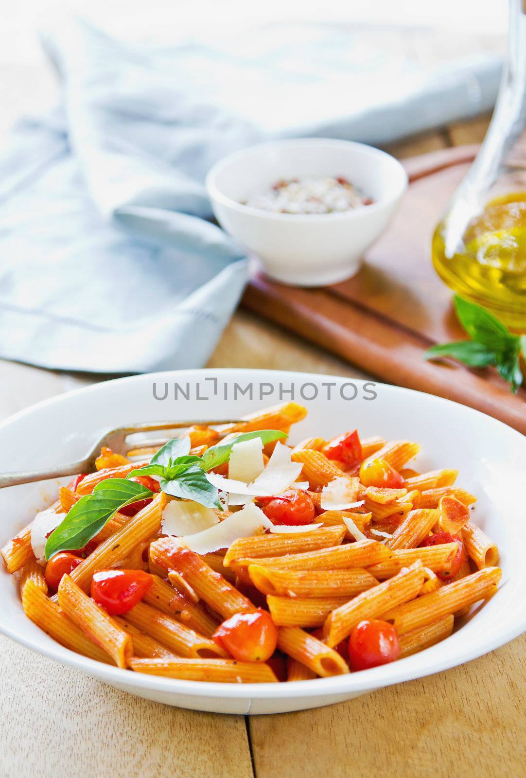 Penne with tomato sauce and shaving Parmesan on top