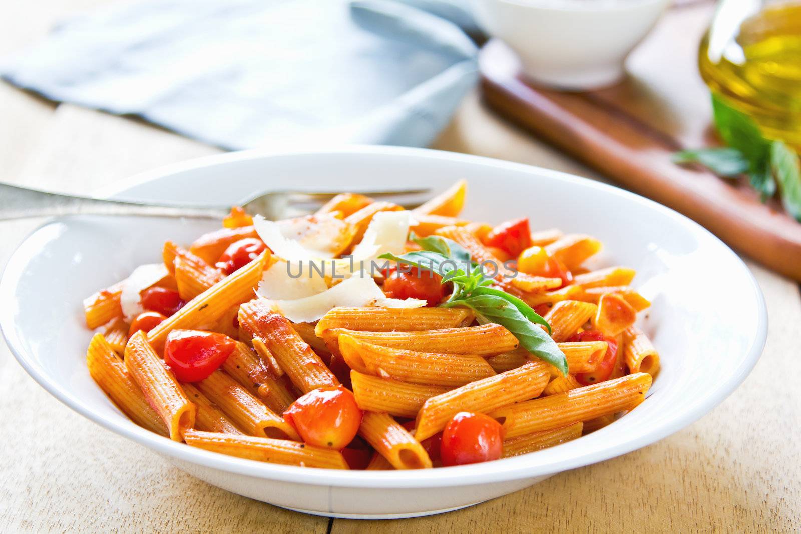 Penne with tomato sauce and shaving Parmesan on top