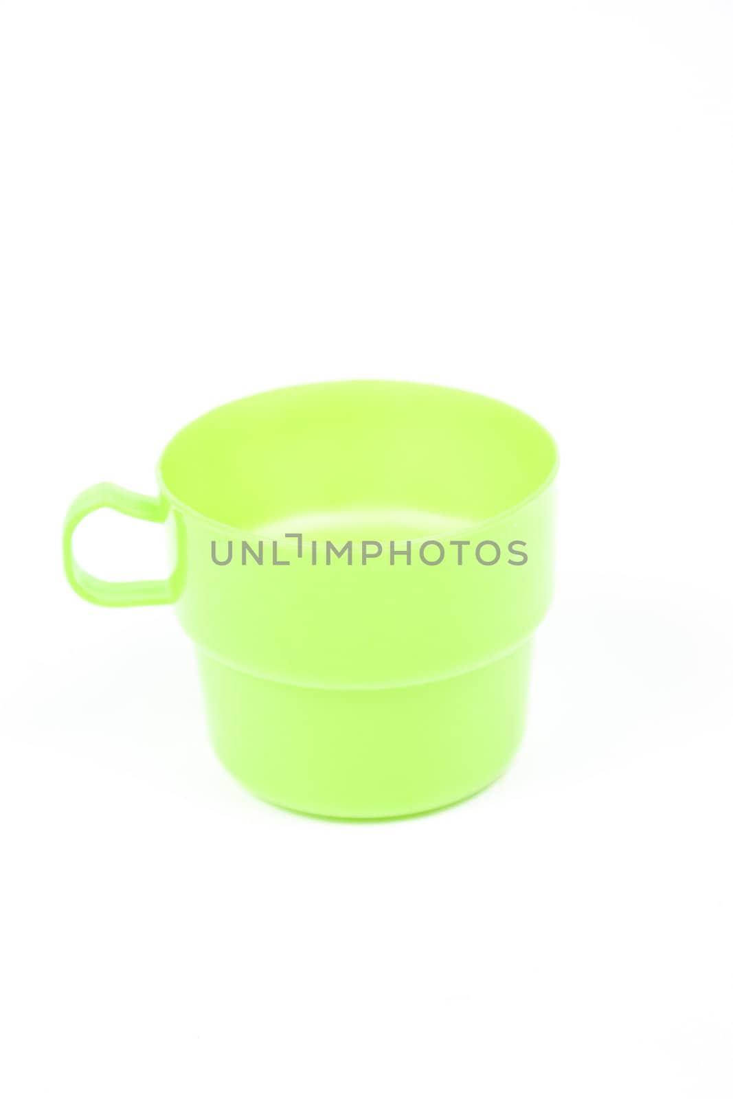 Green plastic glass on white isolated background.object on white isolated backgruond packshot.