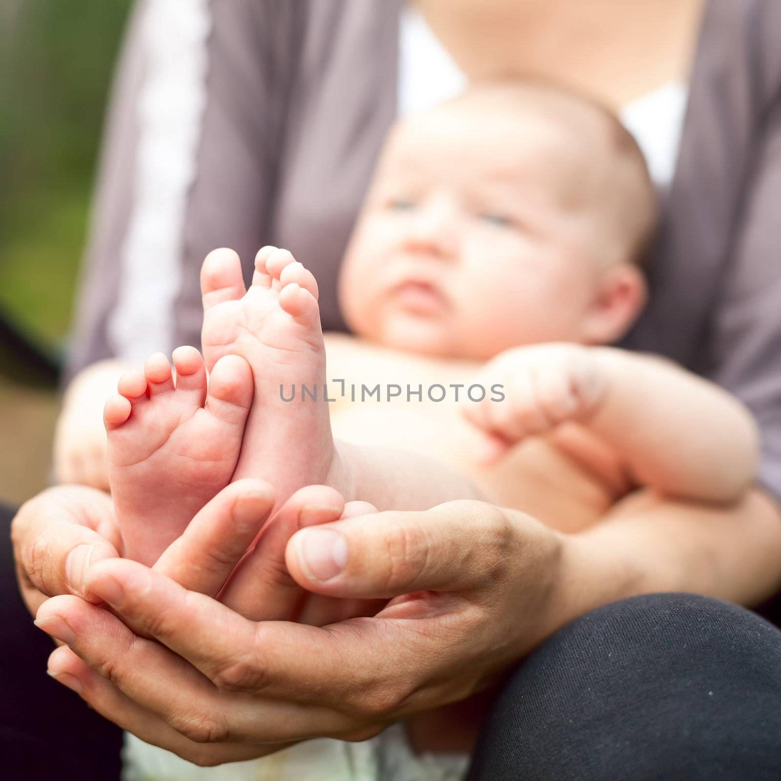 Mother with baby outdoor by naumoid