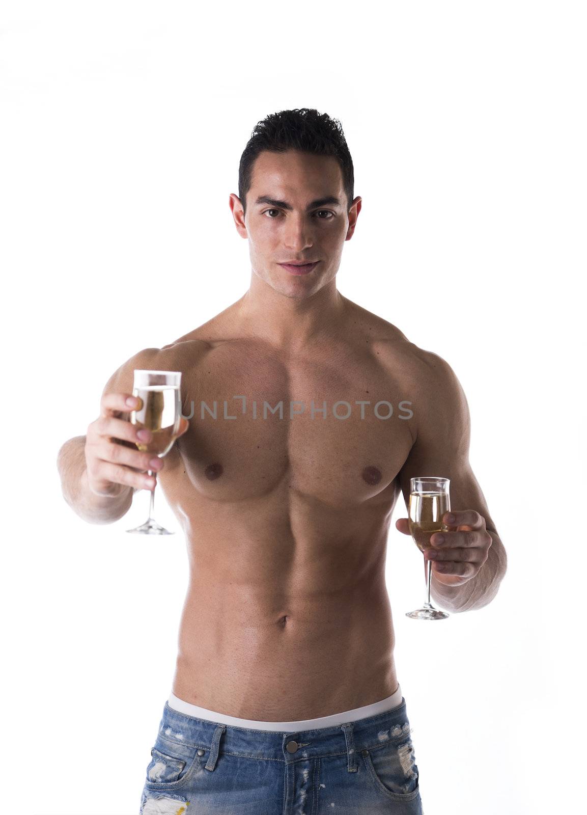 Romantic handsome muscular shirtless young man offering a flute of sparkling champagne to the camera with a smile while holding one for himself, isolated on white