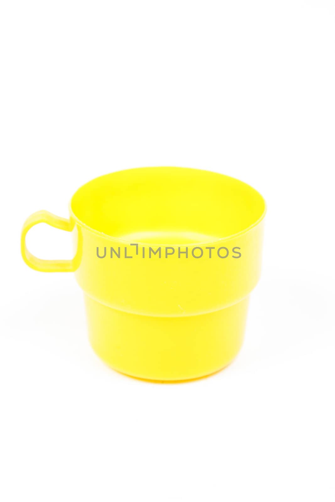 yellow plastic glass on white isolated background.object on white isolated backgruond packshot.