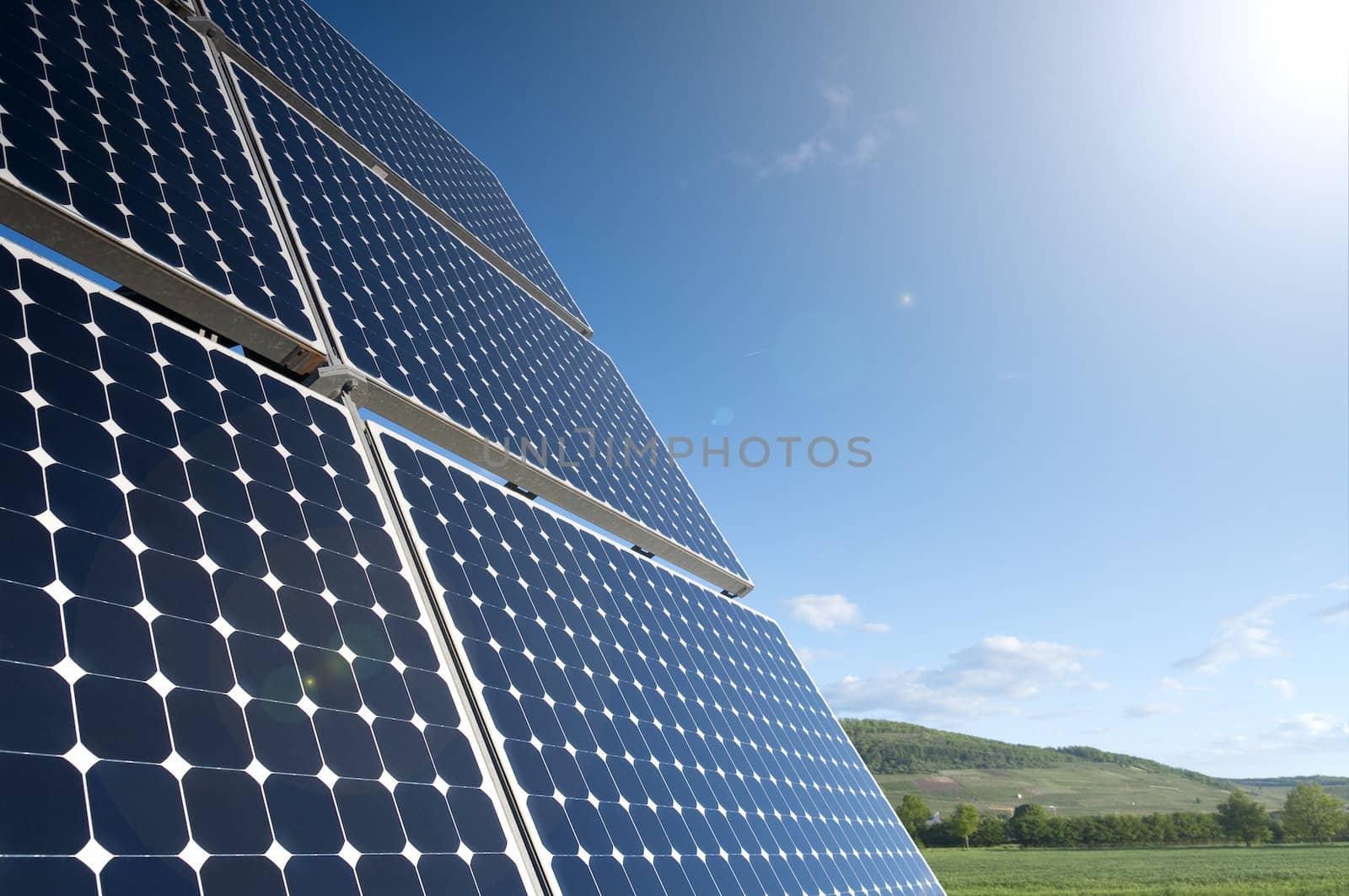 Solar Panel Against Blue Sky With Green Landscape