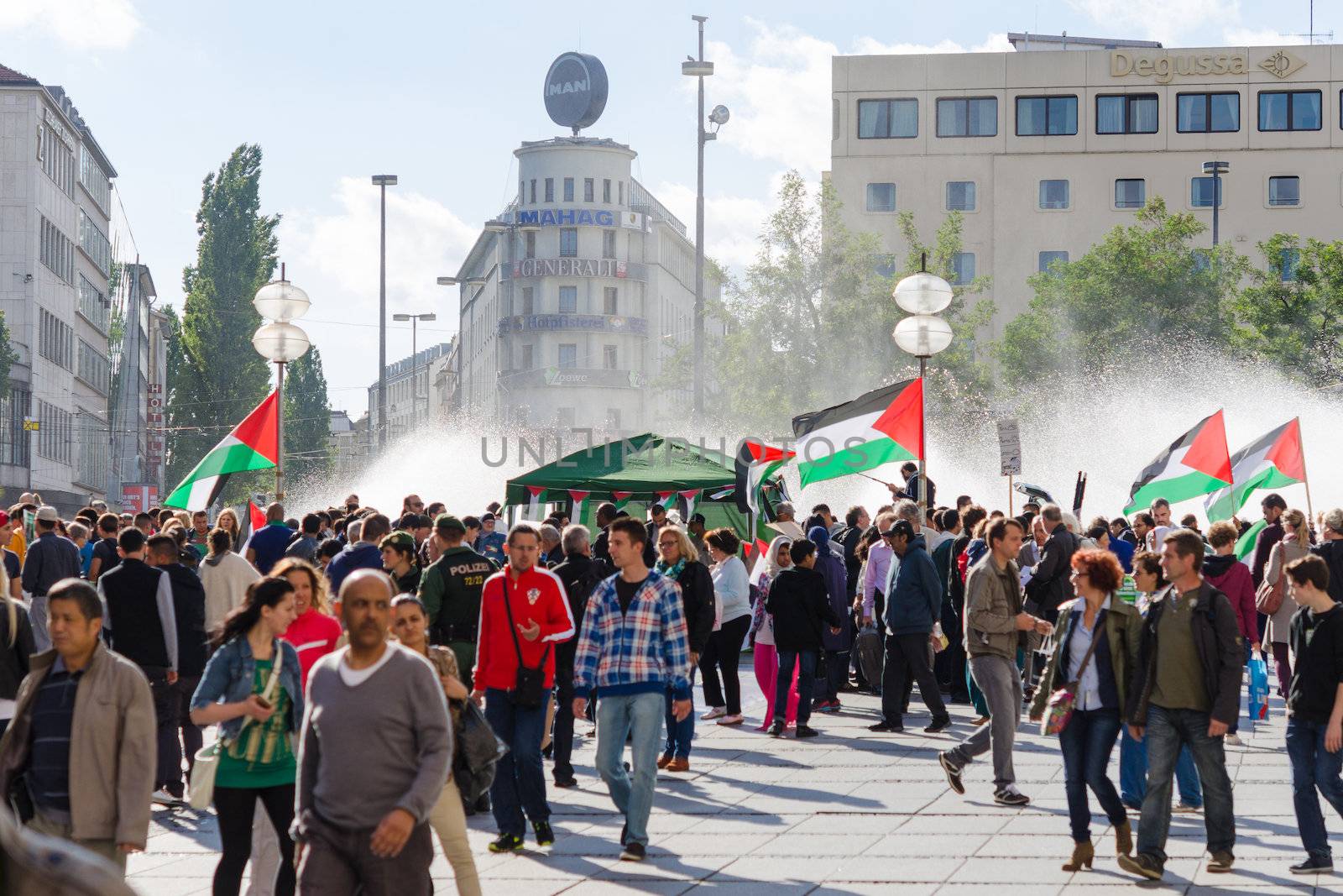 MUNICH, GERMANY - AUGUST 16, 2014: Pacific meeting against the rights infringement of the Palestinian population in Gaza, occupied of Israeli military forces. Activists with flags and slogans call for independence and freedom.