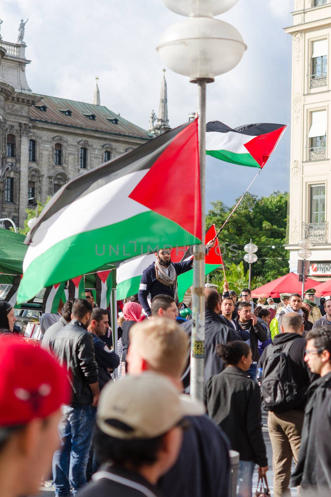 MUNICH, GERMANY - AUGUST 16, 2014: The demonstration in the center of a large European city. Protesters are demanding a peaceful solution to the Arab-Israeli conflict, the cease-fire in Gaza and the liberation of occupied Palestinian territories.