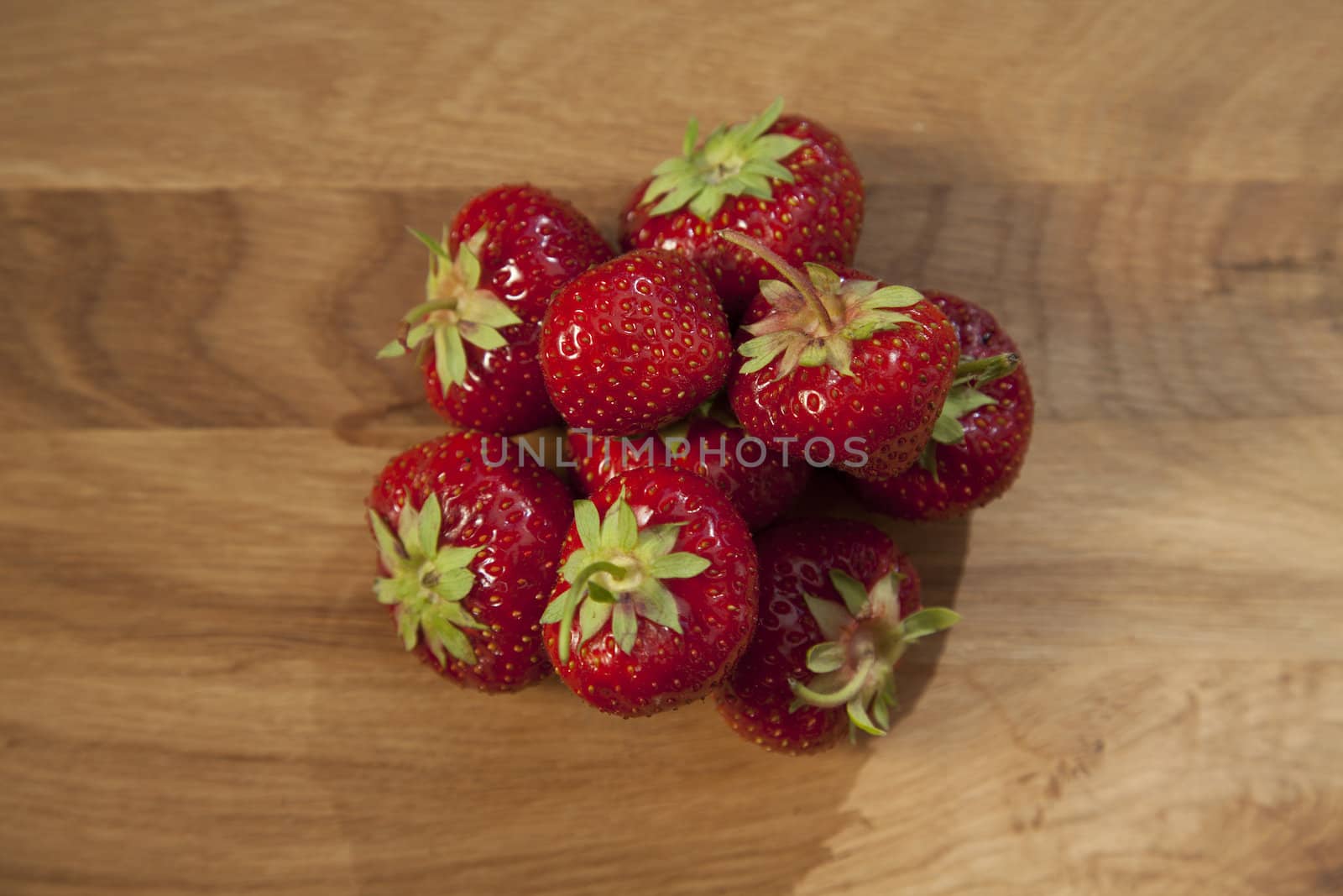 Fresh ripe red strawberries on wooden textured table top