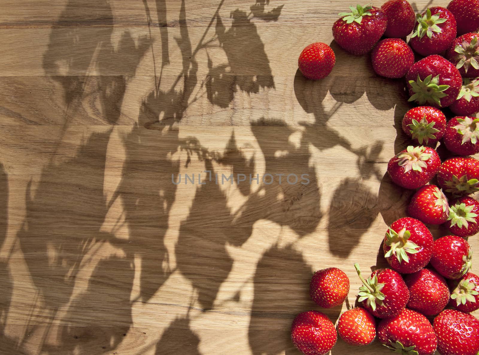 Fresh ripe red strawberries on wooden textured table top