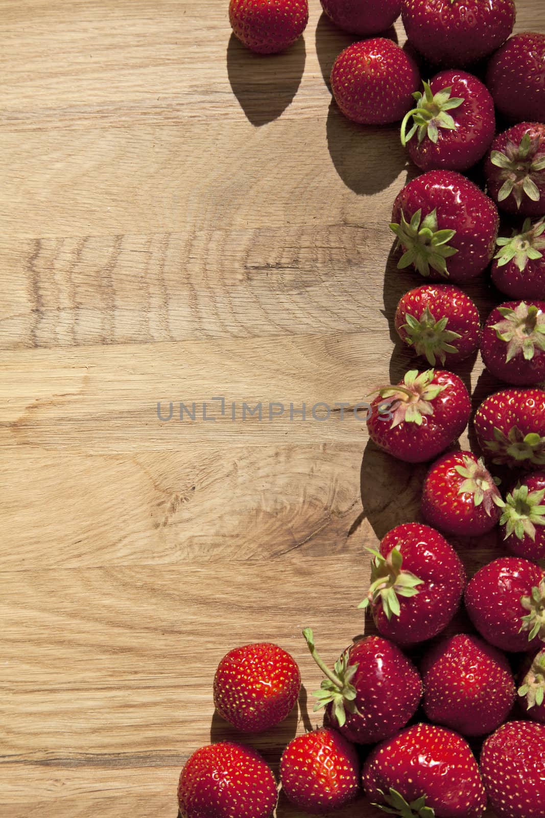 Fresh ripe red strawberries on wooden textured table top