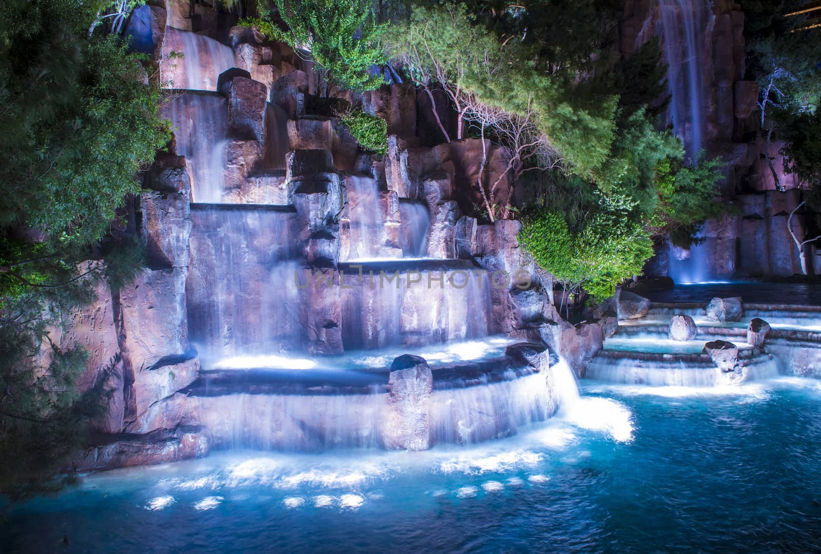 LAS VEGAS - MARCH 15 : Waterfall in front of the entrance to the Wynn Hotel and Casion on March 15, 2014 in Las Vegas. The hotel has 2,716 rooms and it opened in 2005.