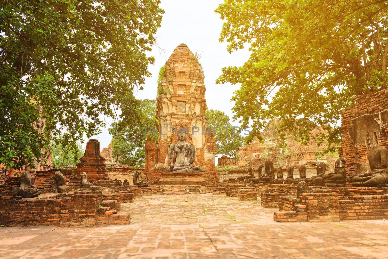 Ruins of old Buddhist Wat Mahathat temple with stupa chedi and destroied Buddha statues, Ayutthaya, Thailand 