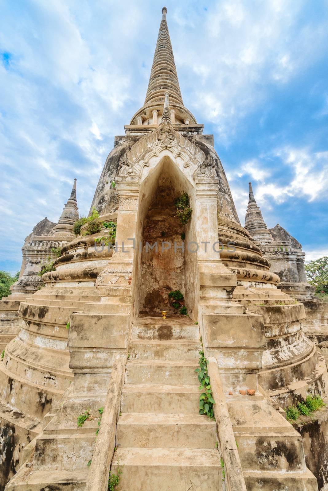 Ruins of ancient stupa chedi at Wat Phra Sri Sanphet Buddhist temple under blue sky. Asian religious architecture in Ayutthaya, Thailand 