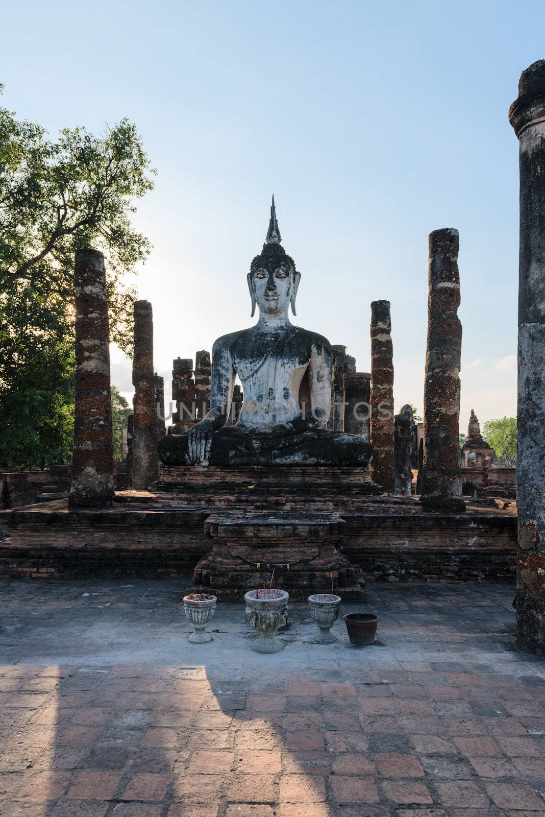 Buddha statue in old Buddhist temple ruins. Buddha statue in Sukhothai historical park Wat Mahathat.