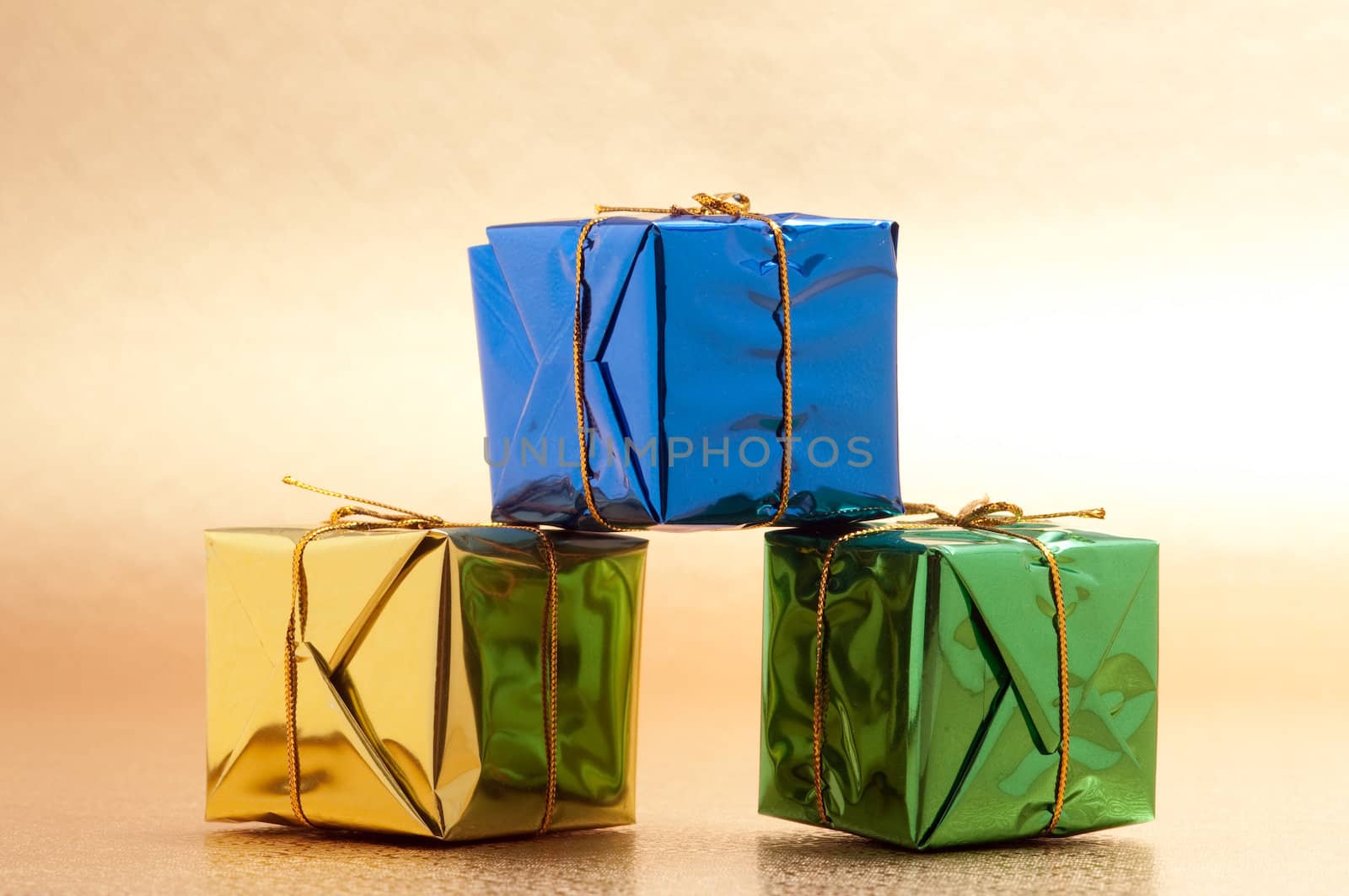 Beautiful wrapped christmas presents with gold background