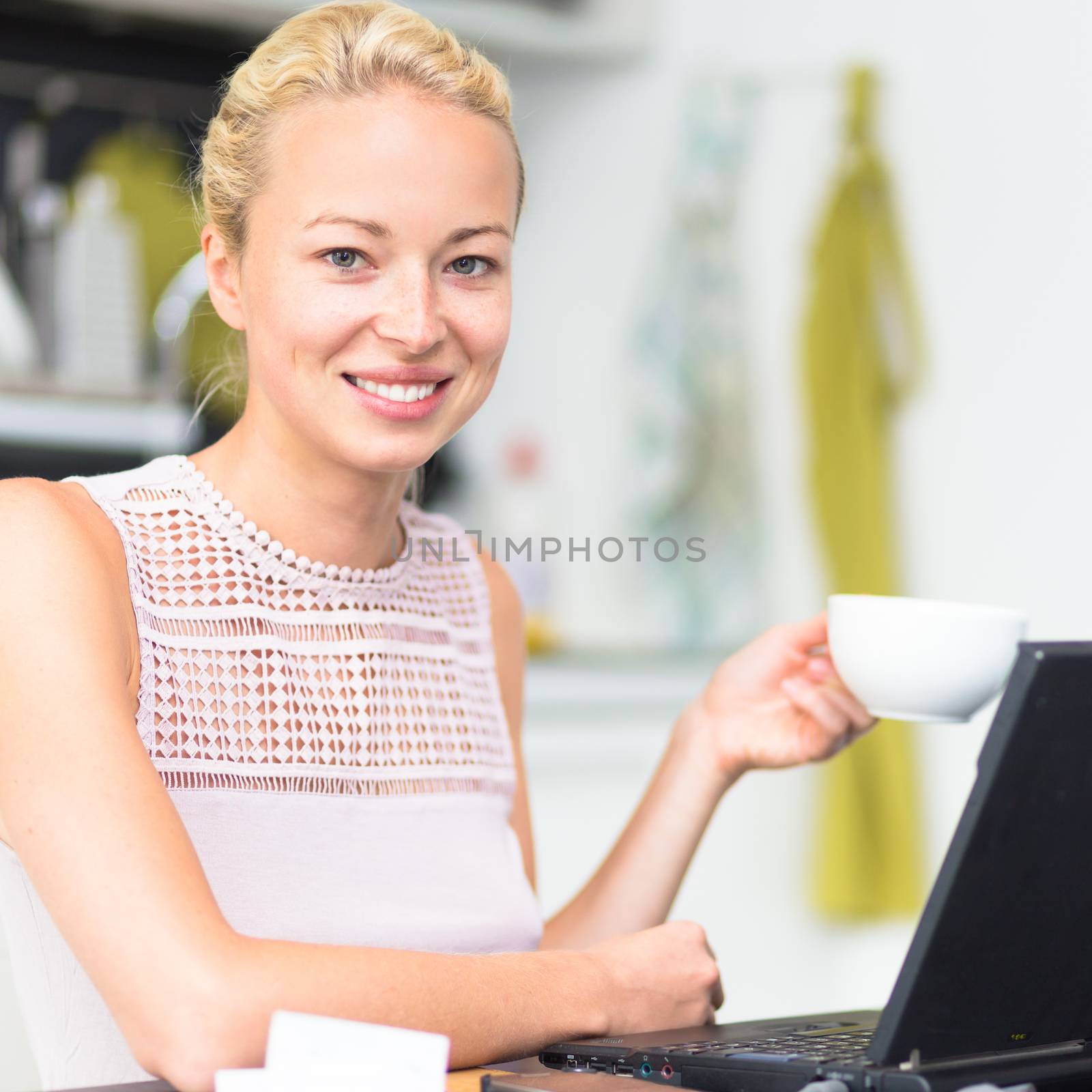 Happy business woman working from her home having more time for her family and her morning coffee.