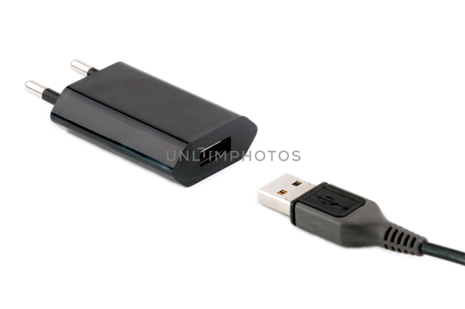 Black USB charger device with USB cable isolated on white