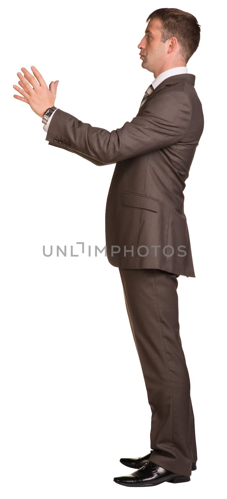 Businessman holding hands up in front of him. Isolated on white background.