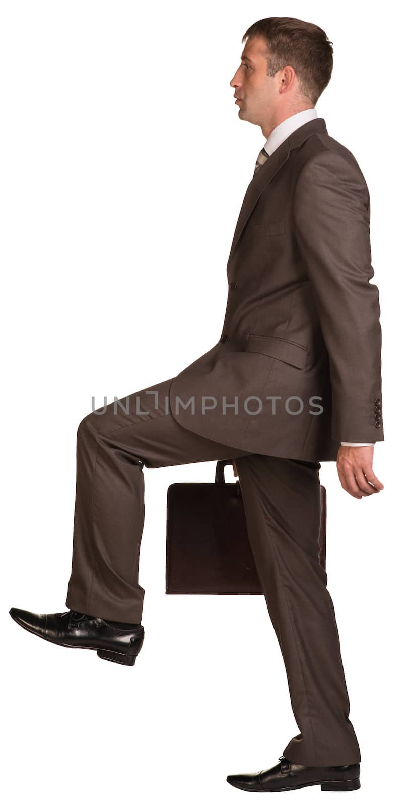 Walking businessman with briefcase. Isolated on the white background.