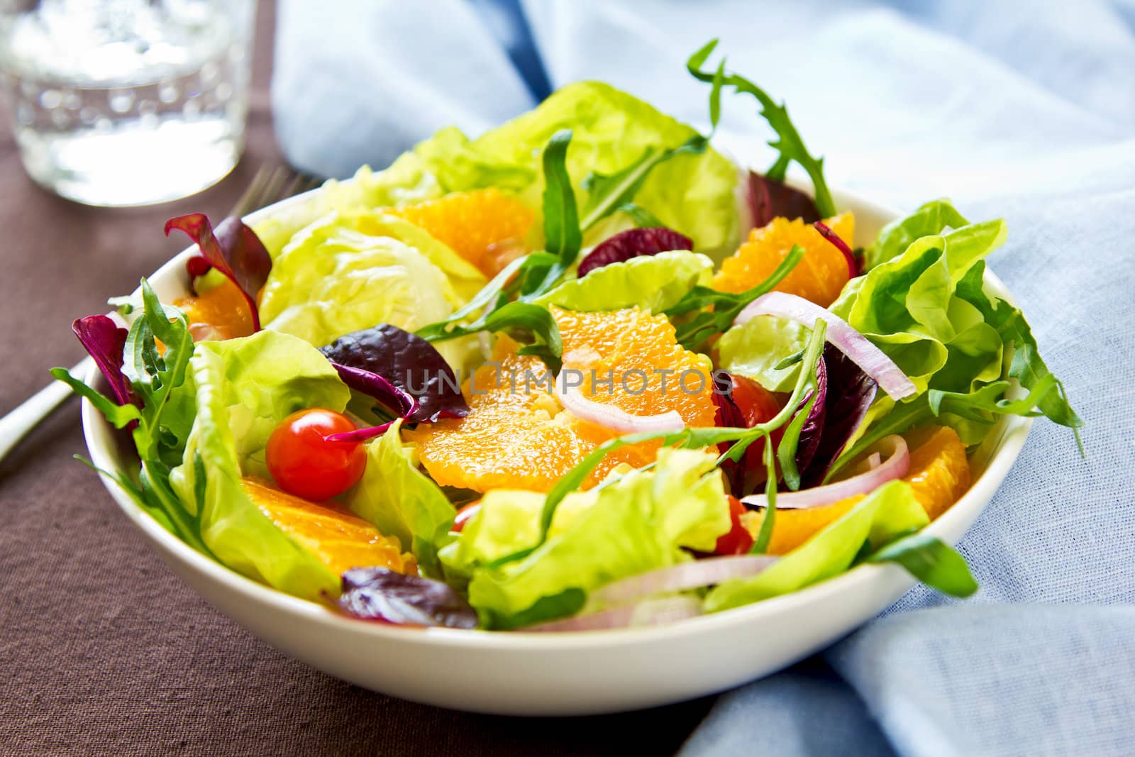 Orange with rocket and pomegranate salad in a bowl