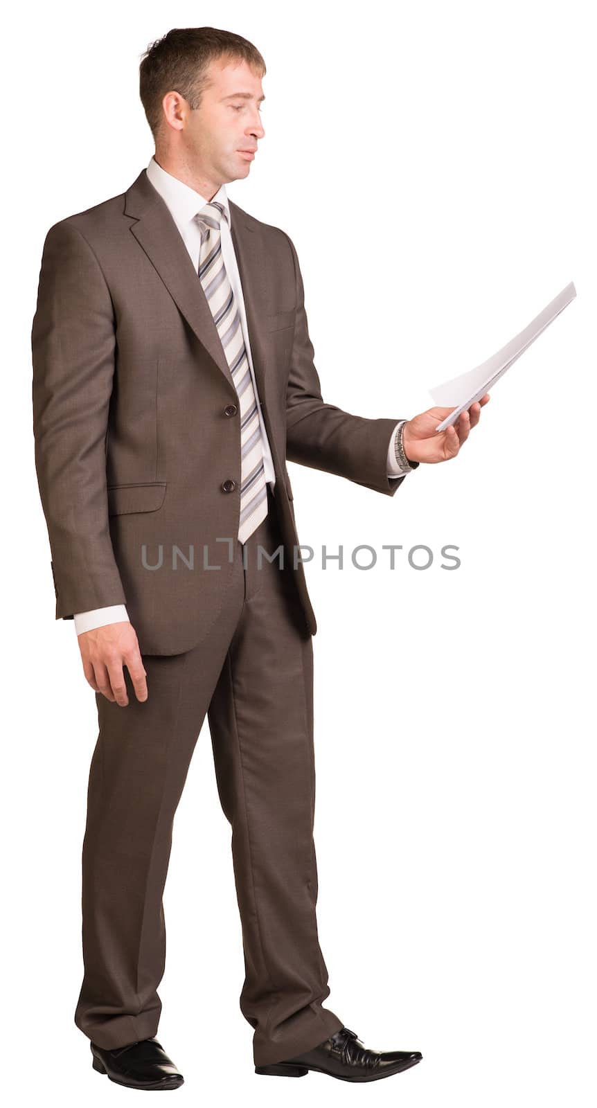 Standing businessman looking at paper sheet by cherezoff