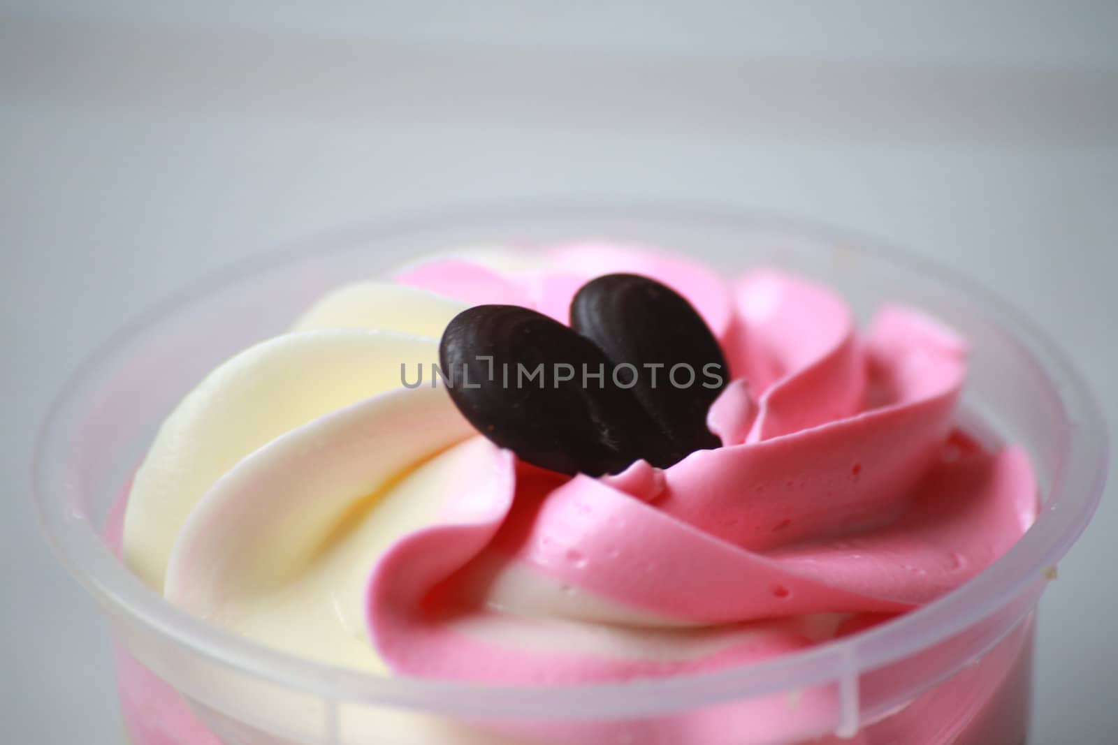This is a cup cake in taste of vanila and strawberry.It's decorate by chocolate in a shape of heart,looks be appetizing.