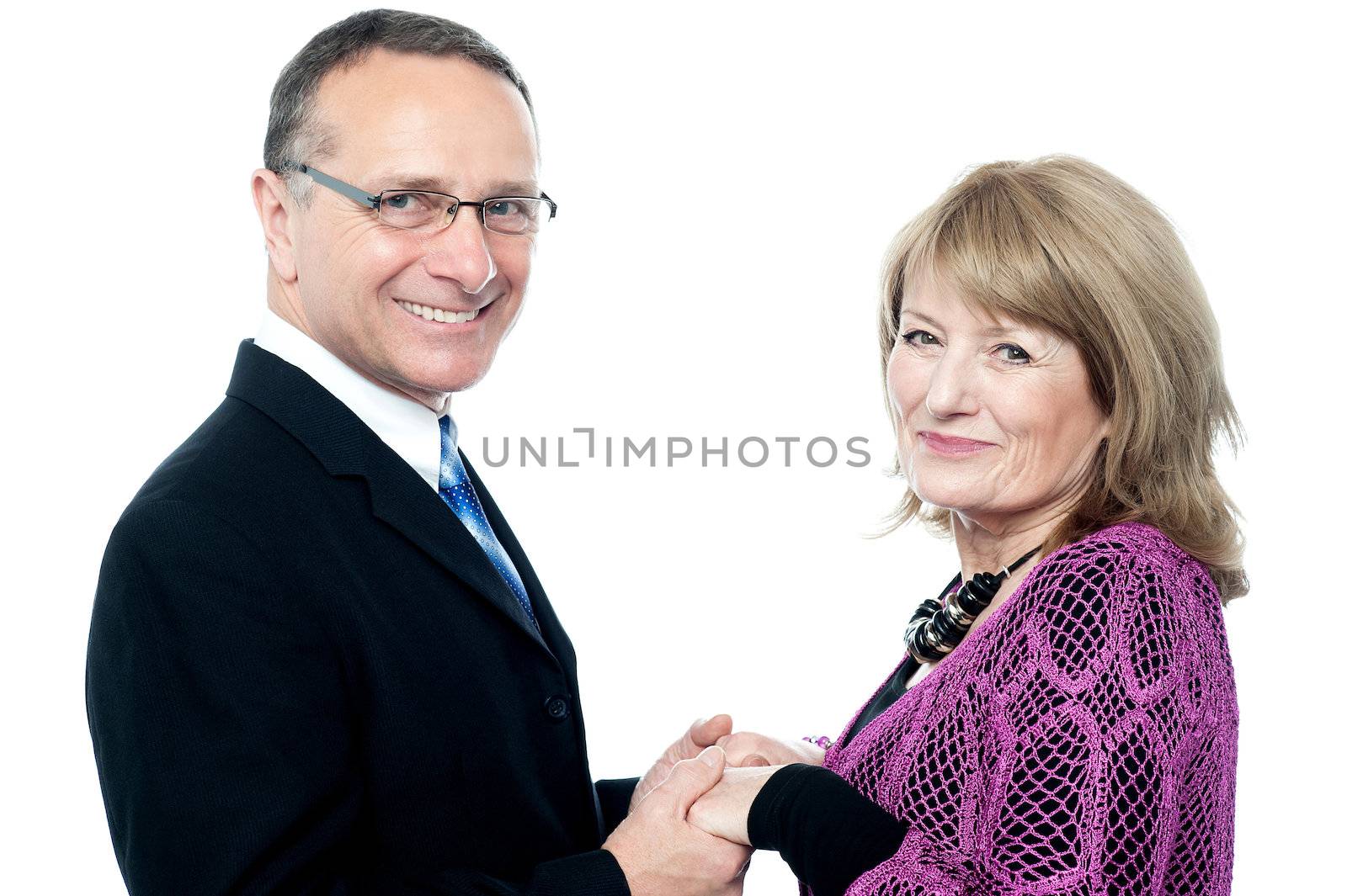 Smiling mature couple with holding hands