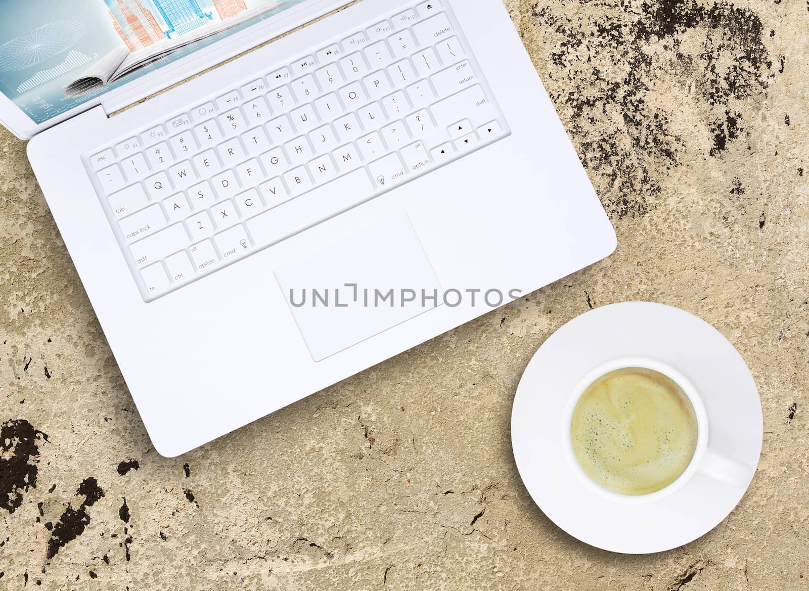 Laptop and coffee cup on old concrete surface. Computer technology concept