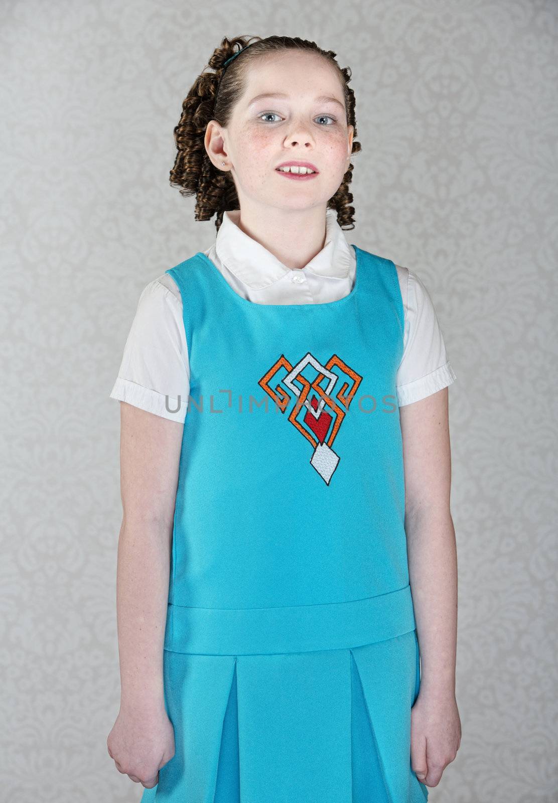 Confident little Irish girl with curls and blue dress