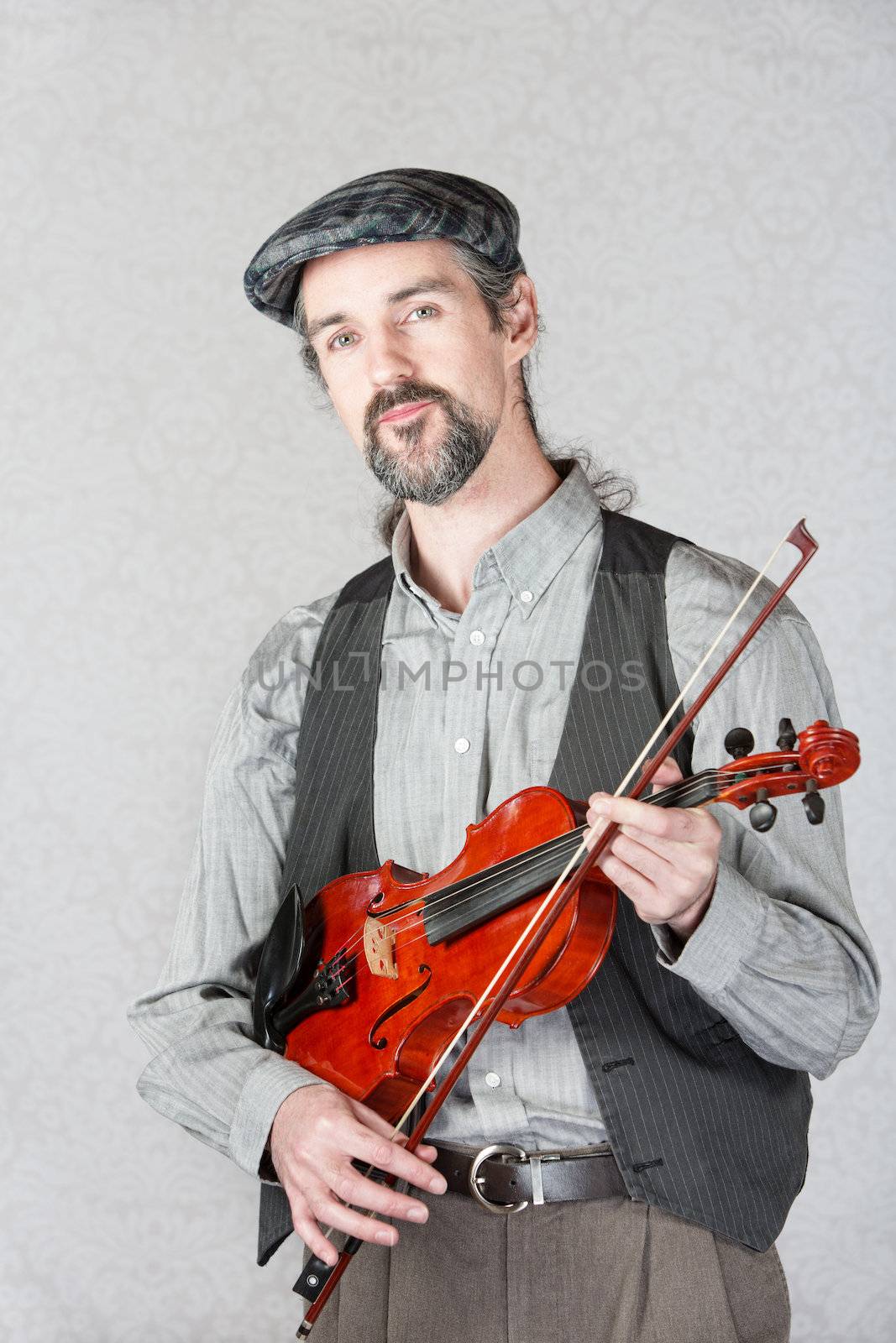 Serious Irish man with beard holding fiddle