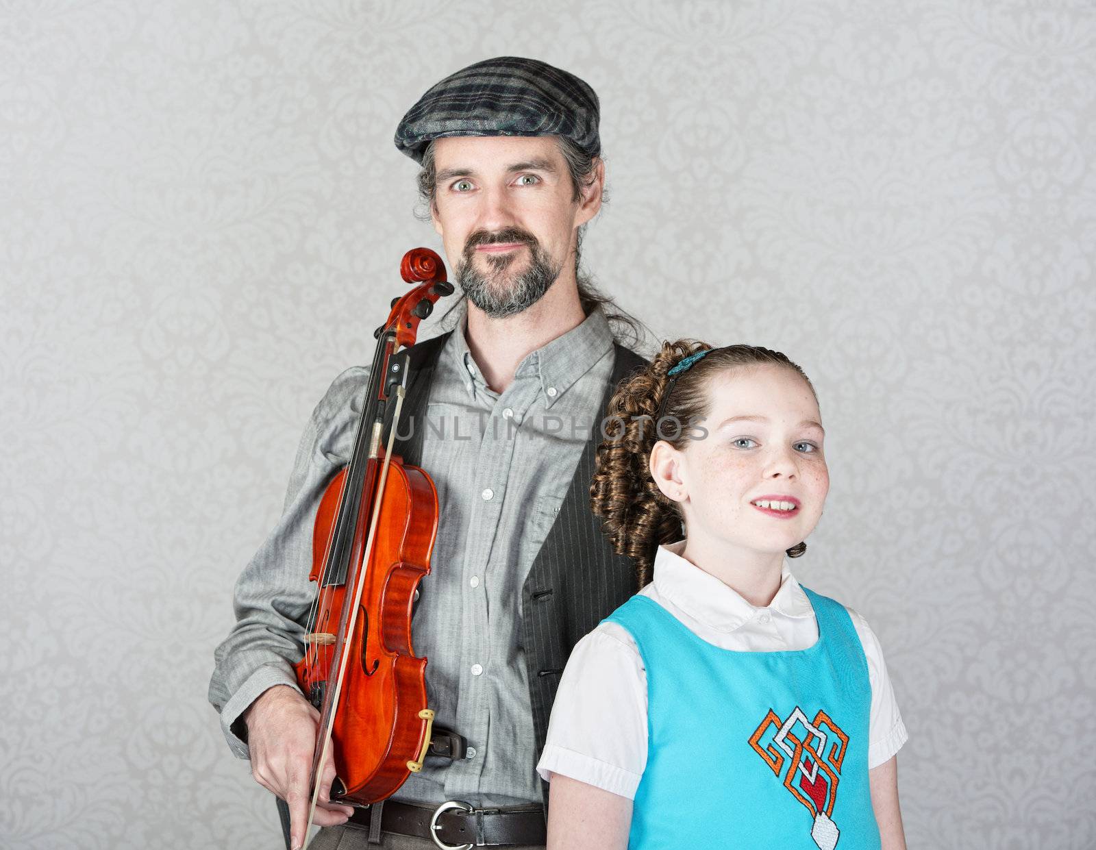Irish folk music parent holding violin with cute child 