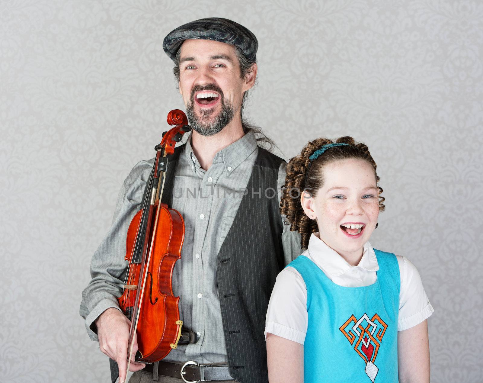 Laughing Irish folk fiddle player with happy child