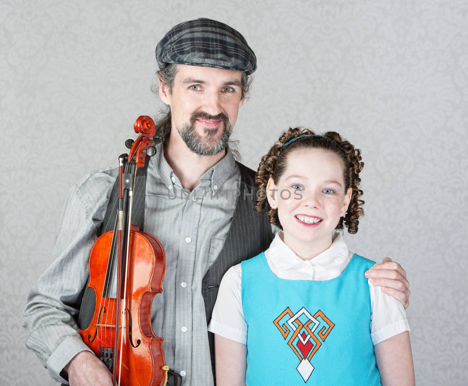 Irish folk fiddler in beard holding violin with child