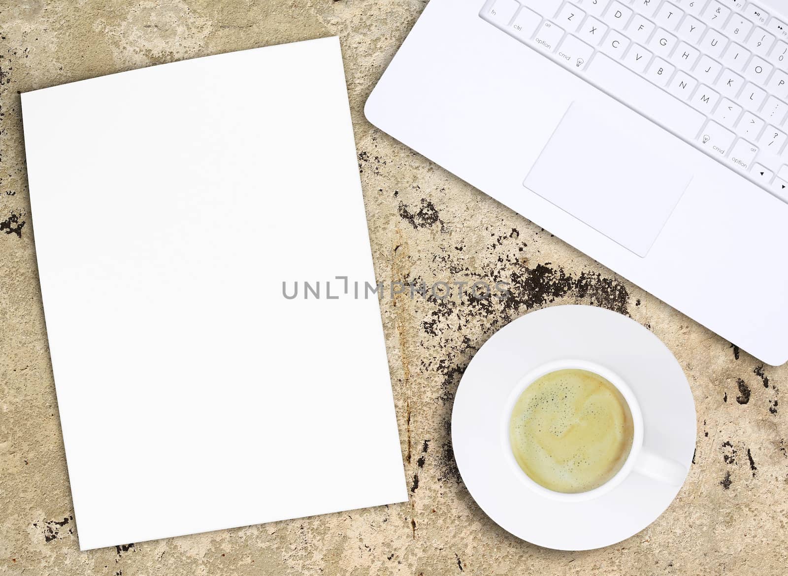 Laptop and coffee cup on old concrete surface. Computer technology concept